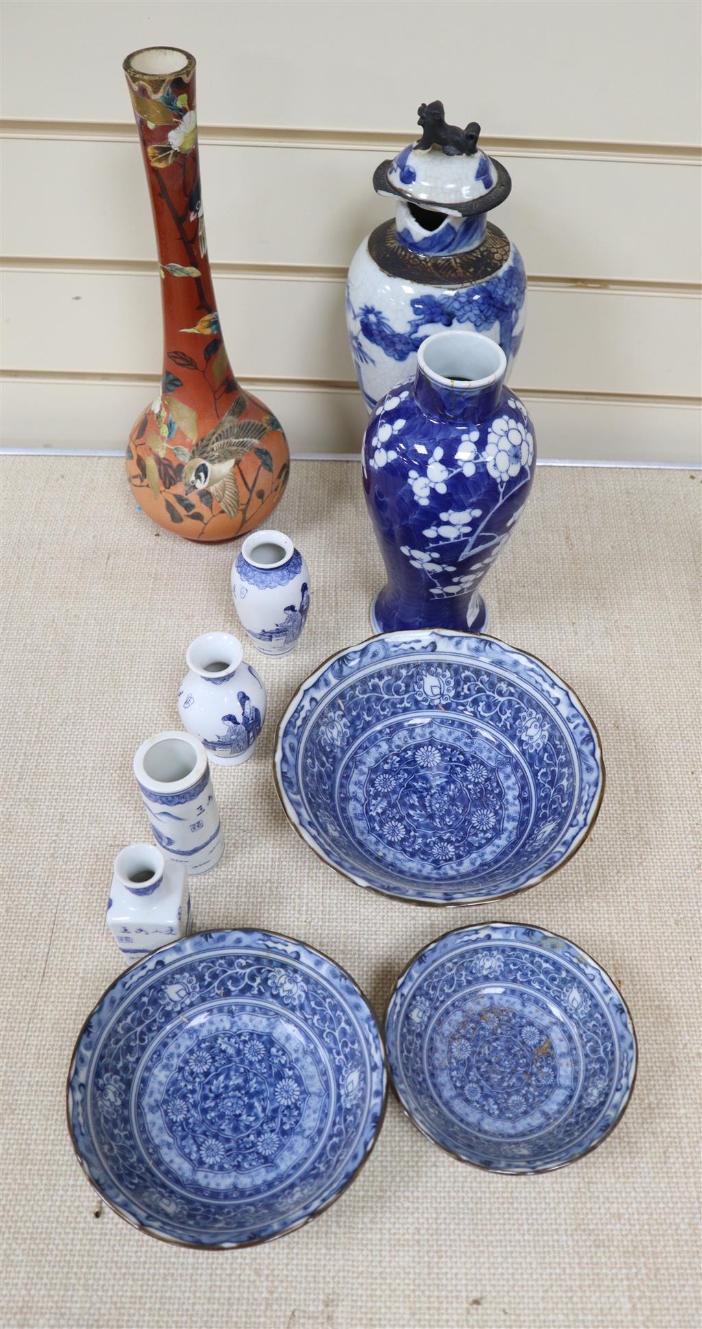 A graduated set of three Chinese porcelain blue and white bowls, largest 19cm and a group of four miniature Chinese blue and white vase